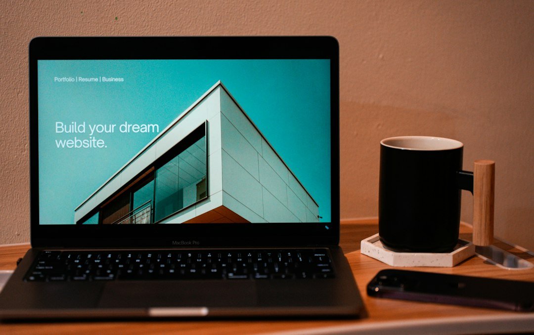 Laptop and coffee on a table while planning a simple Elementor Free website
