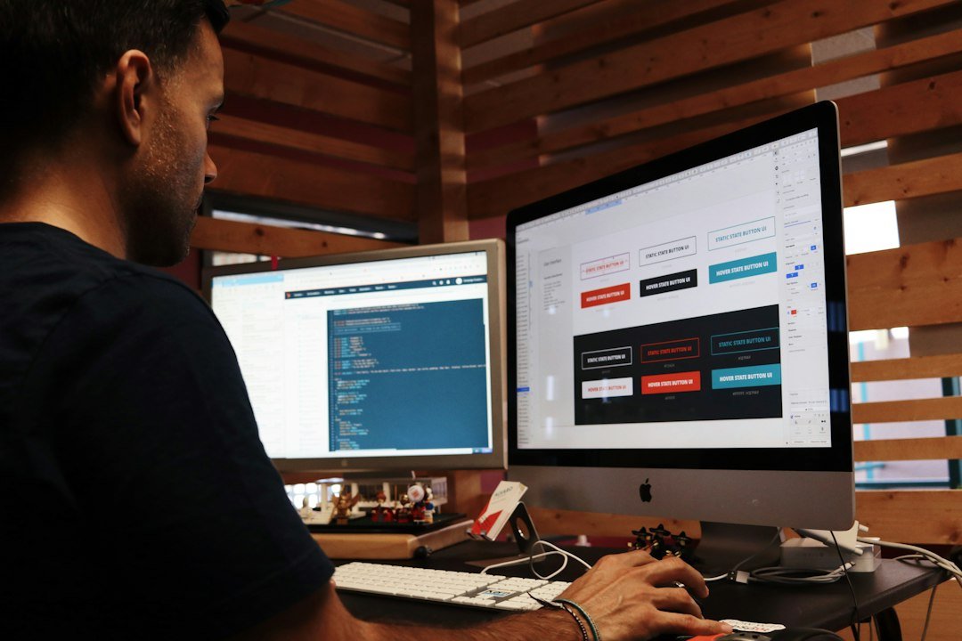 Person working on a Mac, choosing a website platform for a business