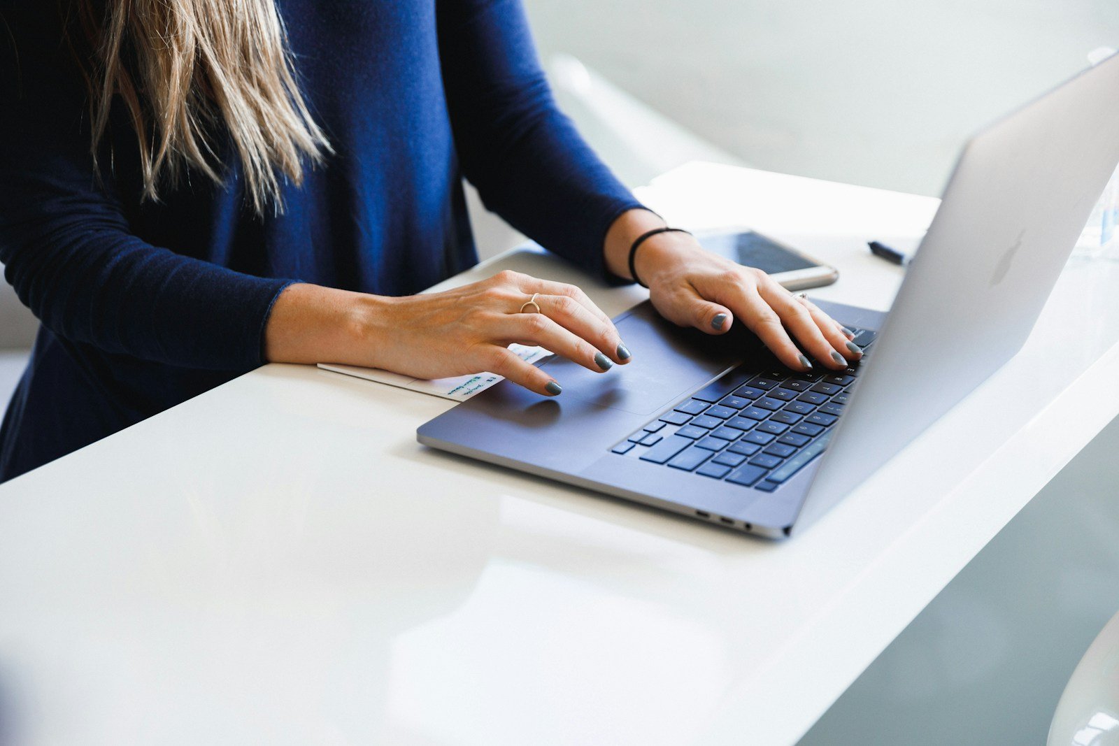Person at a desk editing a website on a laptop